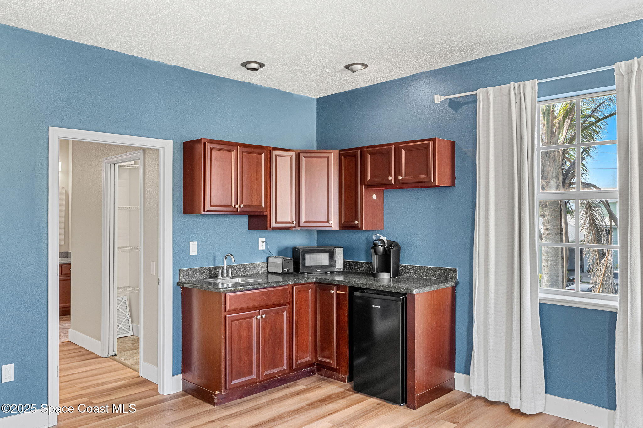 48 Harbor Circle Cocoa Beach, FL 32931 - Photo 20 of 48 a kitchen with stainless steel appliances granite countertop a sink stove and cabinets