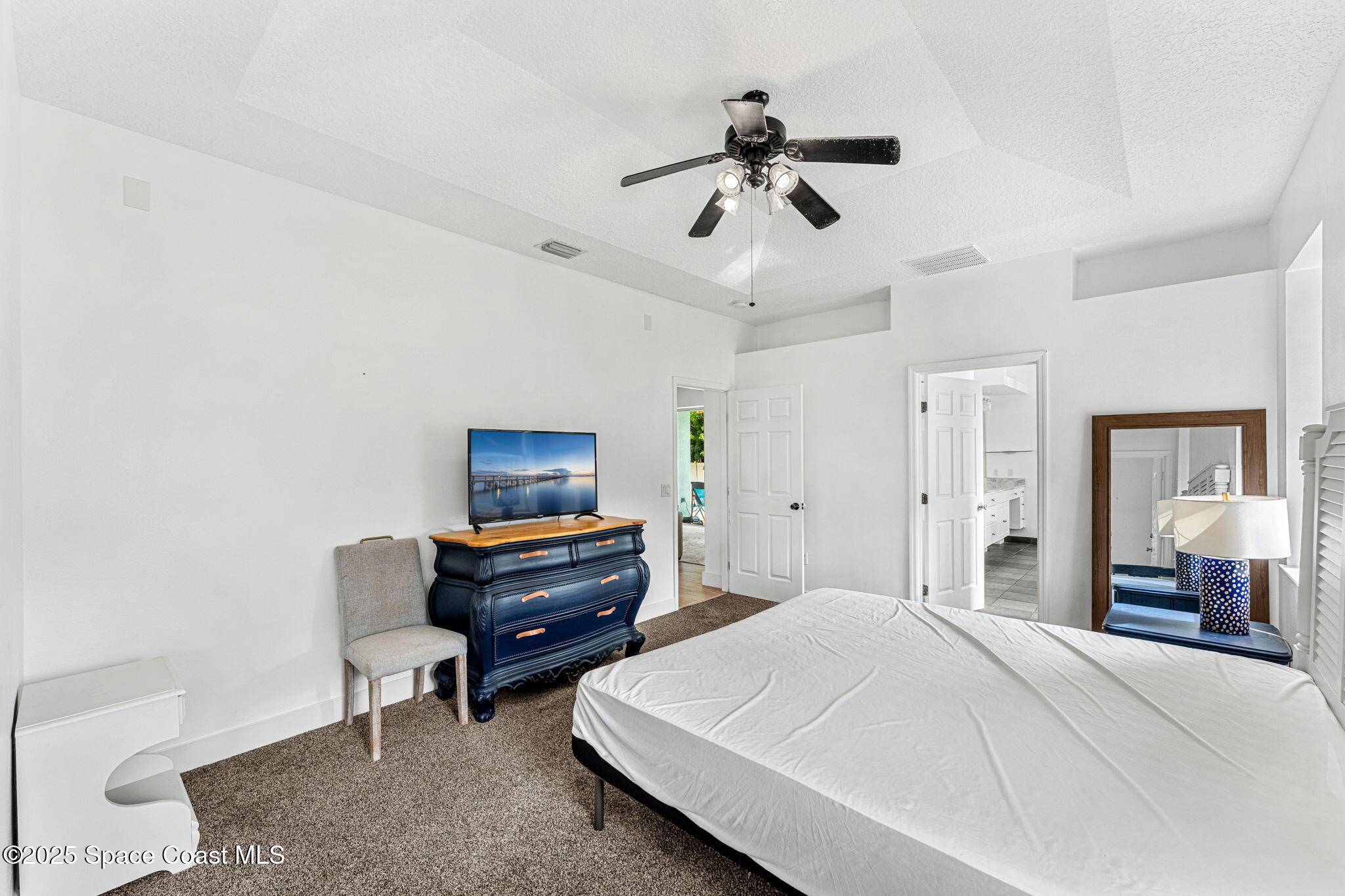 48 Harbor Circle Cocoa Beach, FL 32931 - Photo 23 of 48 a bedroom with a bed and a chandelier