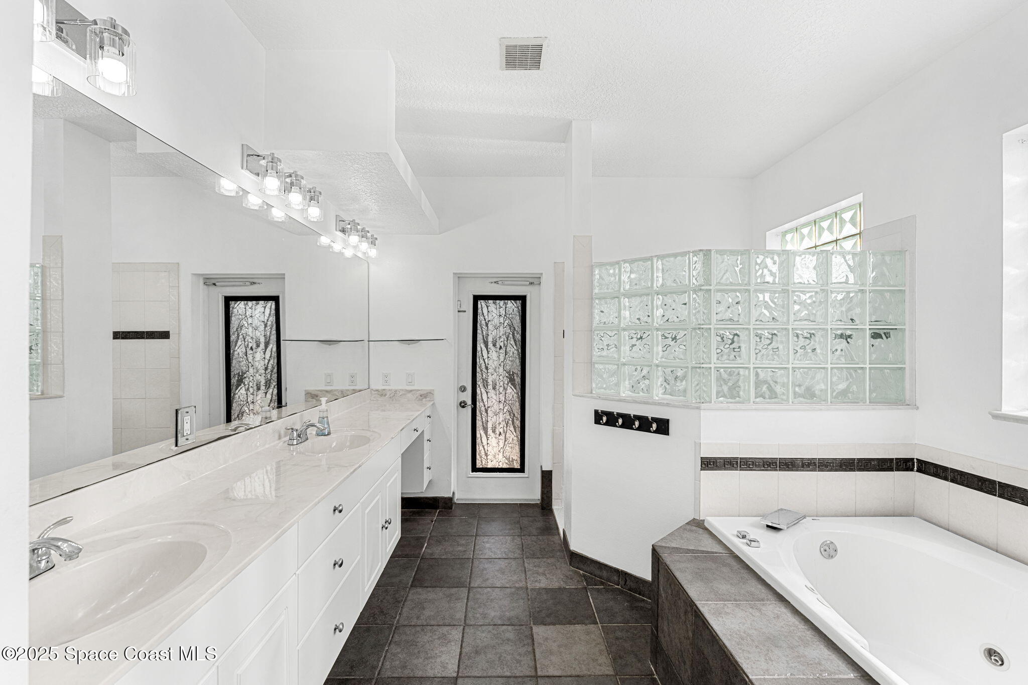 48 Harbor Circle Cocoa Beach, FL 32931 - Photo 24 of 48 a bathroom with a tub sink and mirror