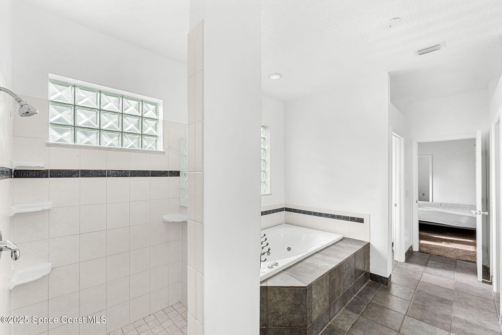 48 Harbor Circle Cocoa Beach, FL 32931 - Photo 25 of 48 a bathroom with a bathtub and a shower