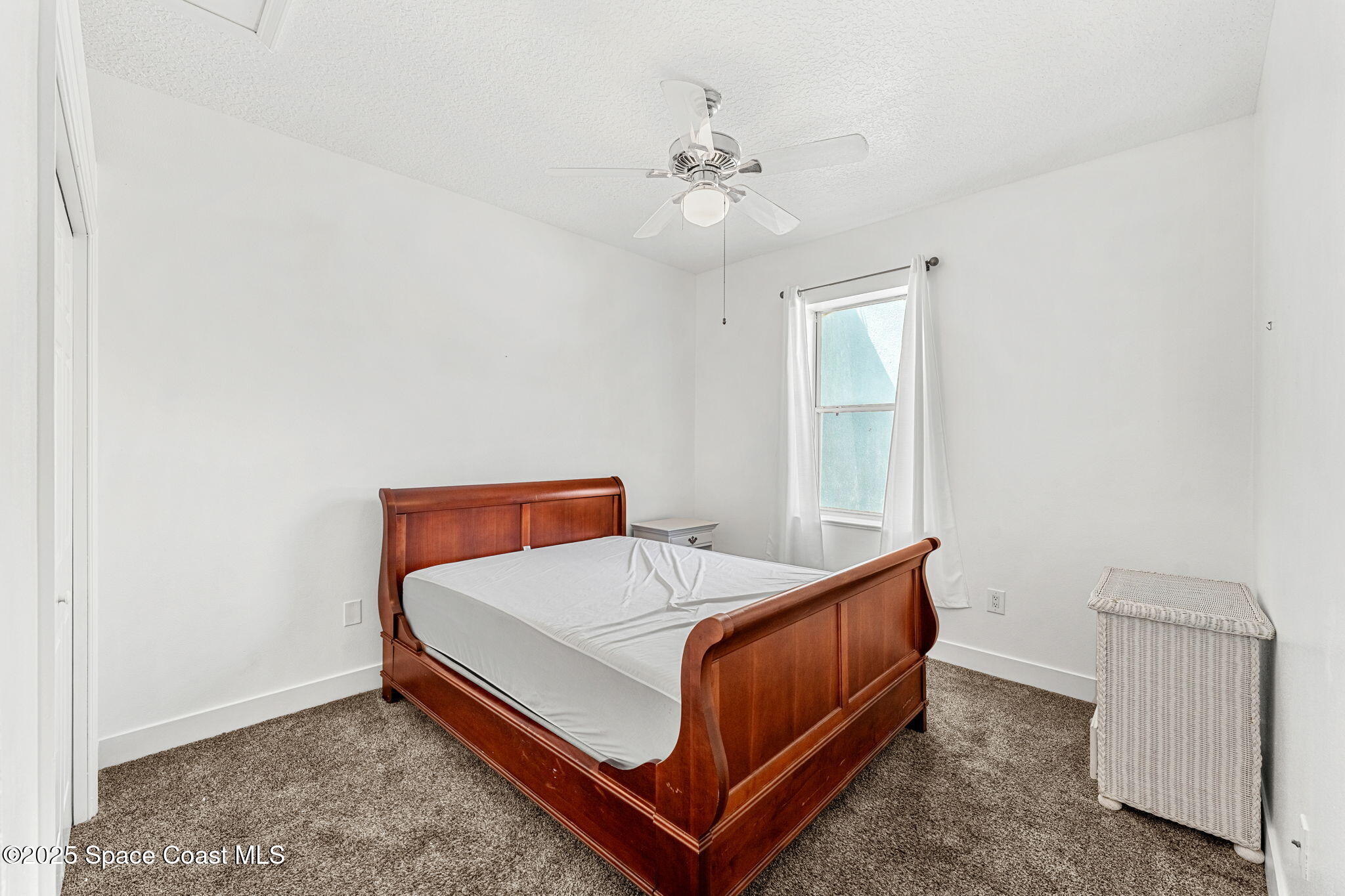 48 Harbor Circle Cocoa Beach, FL 32931 - Photo 31 of 48 a bed sitting in a bedroom next to a window