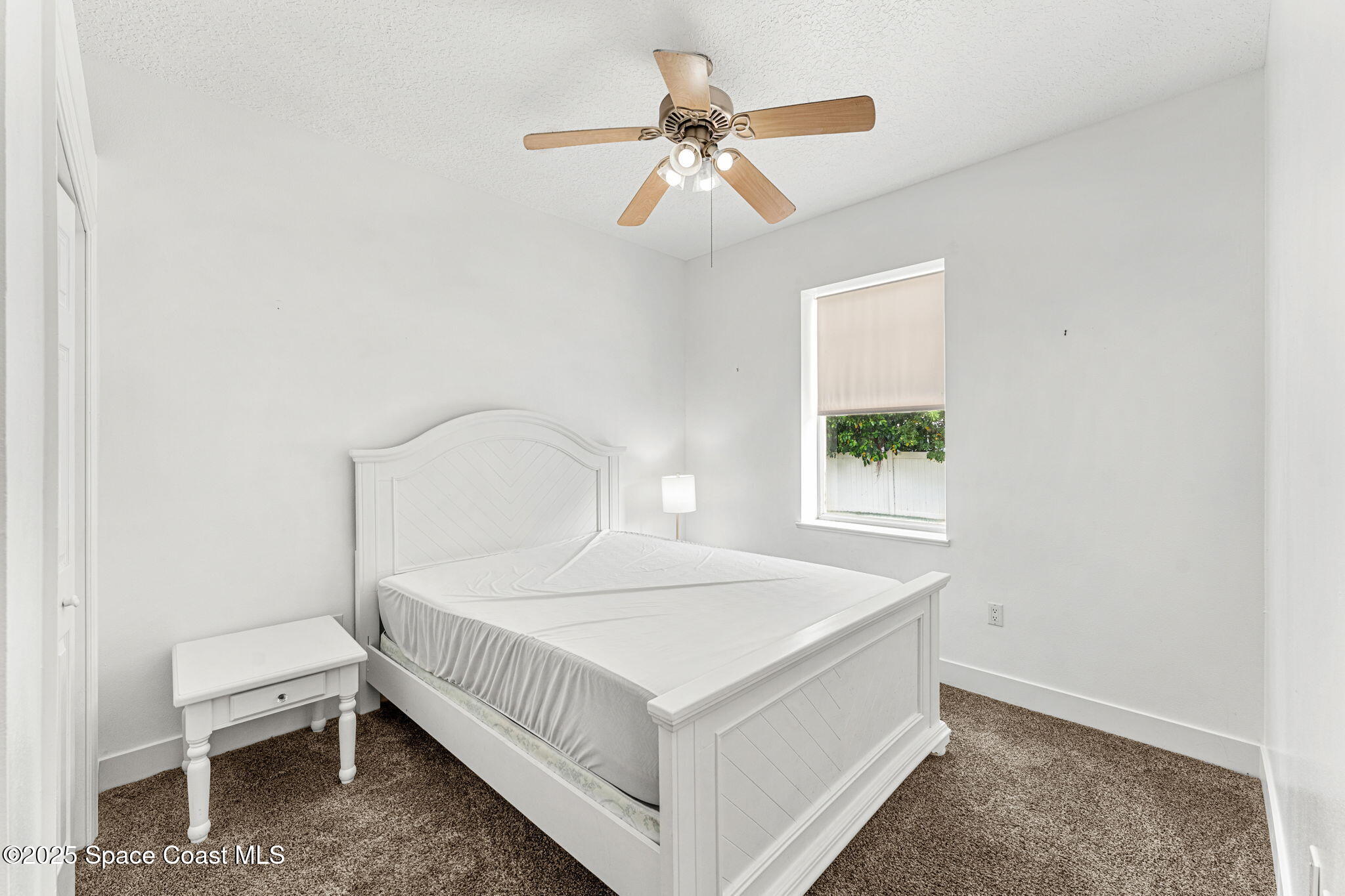 48 Harbor Circle Cocoa Beach, FL 32931 - Photo 32 of 48 a bedroom with a bed and a window