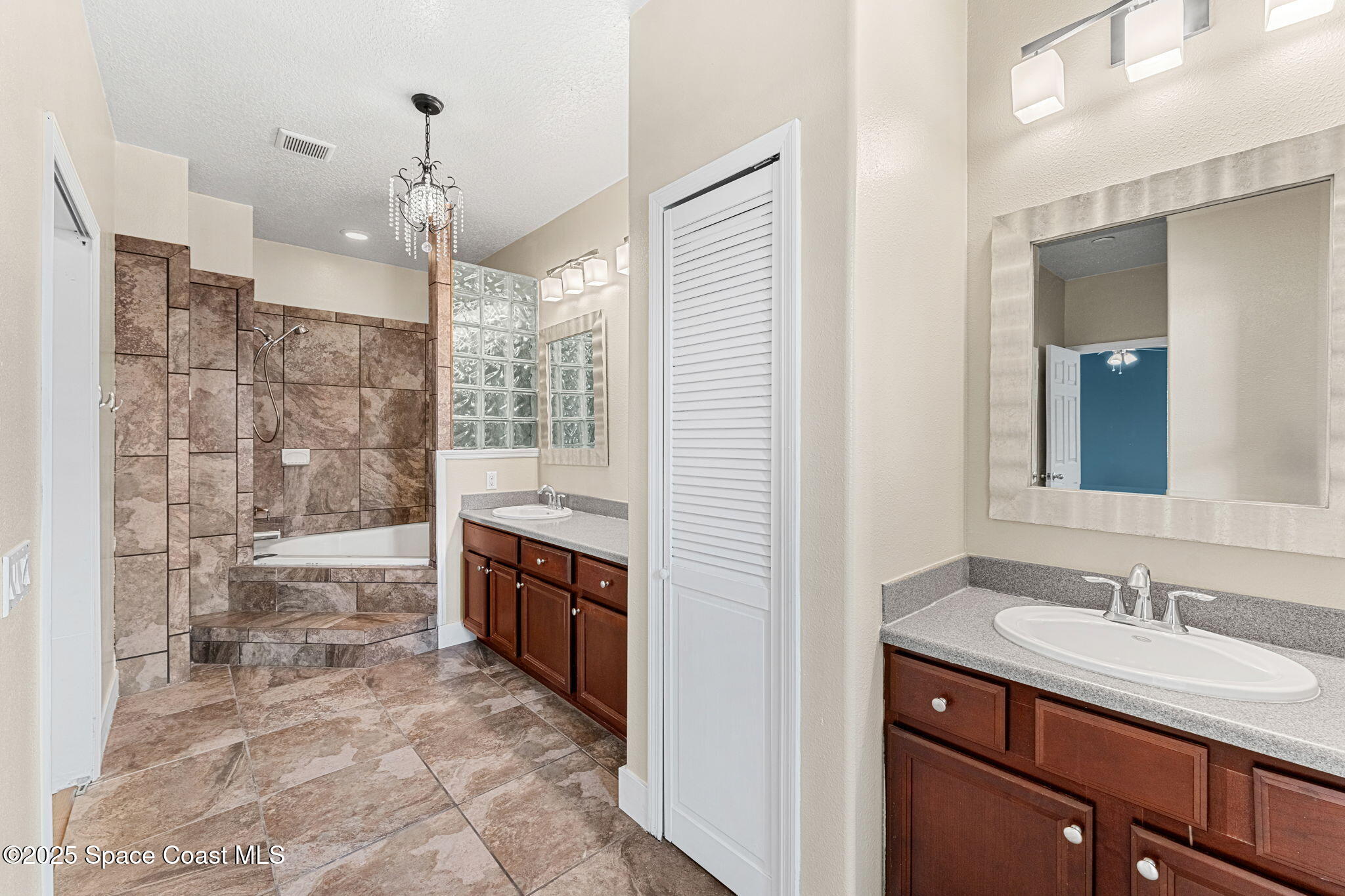 48 Harbor Circle Cocoa Beach, FL 32931 - Photo 33 of 48 a bathroom with a granite countertop sink a toilet a mirror and shower