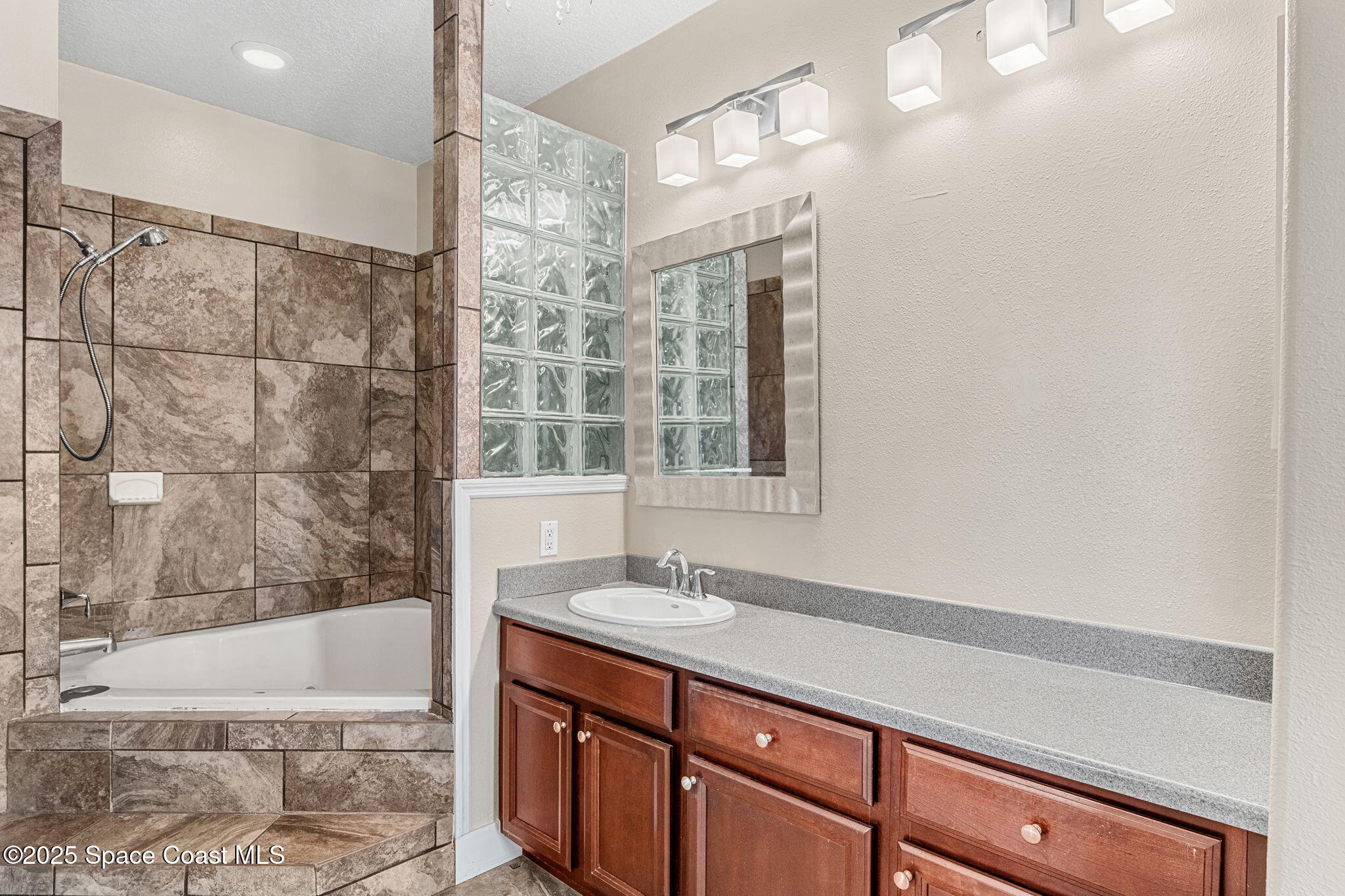 48 Harbor Circle Cocoa Beach, FL 32931 - Photo 34 of 48 a bathroom with a sink a vanity and a bathtub