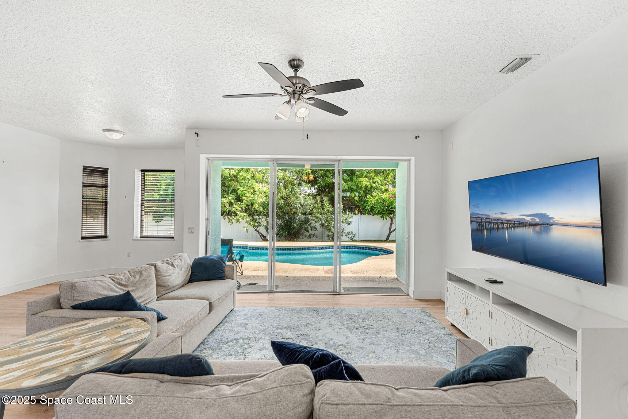 48 Harbor Circle Cocoa Beach, FL 32931 - Photo 9 of 48 a living room with furniture and a large window