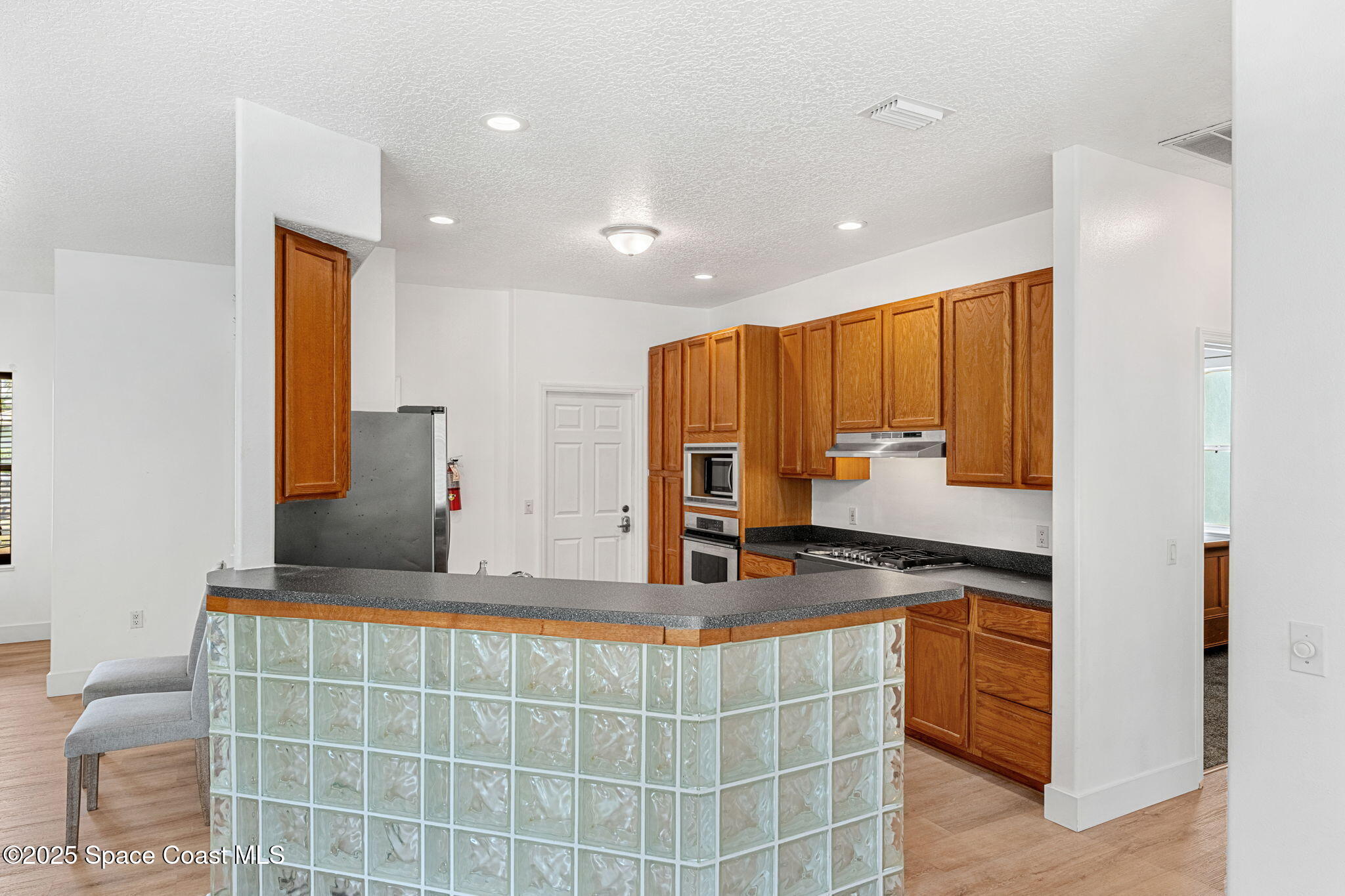 48 Harbor Circle Cocoa Beach, FL 32931 - Photo 10 of 48 a kitchen with kitchen island granite countertop a sink and a stove top oven