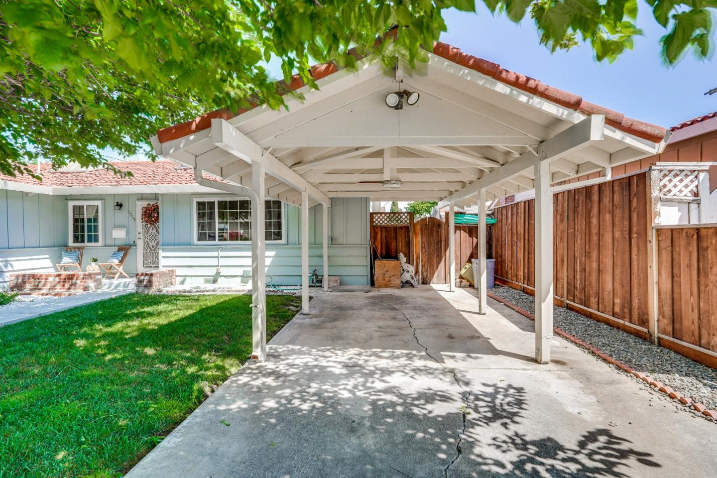 1755 Ravizza Avenue Santa Clara, CA 95051 - Photo 5 of 36 a view of a backyard with table and chairs under an umbrella