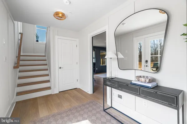 a spacious bathroom with a granite countertop sink and a mirror