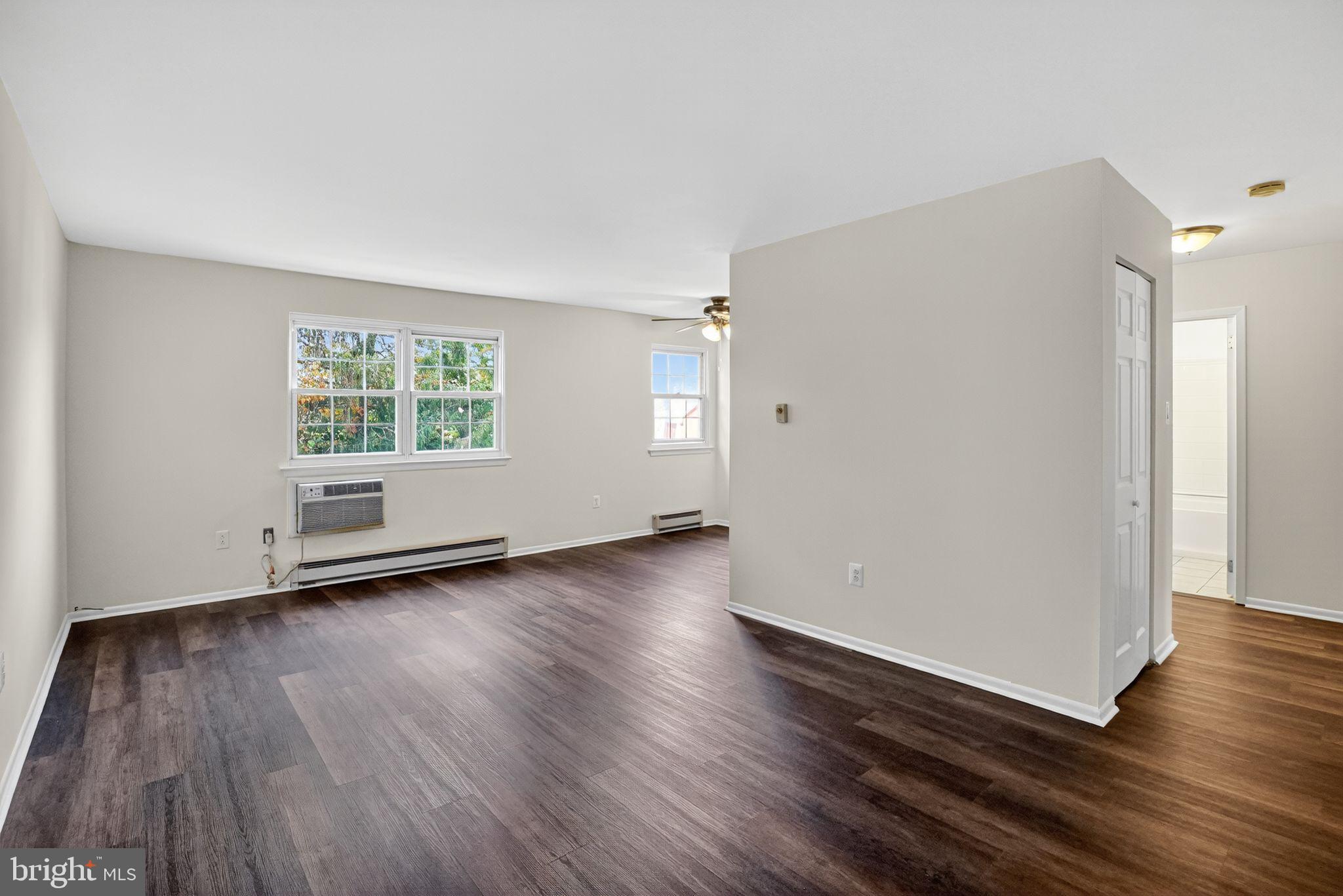 178 Elephant Road, Unit A6 Dublin, PA 18917 - Photo 2 of 17 an empty room with wooden floor and windows