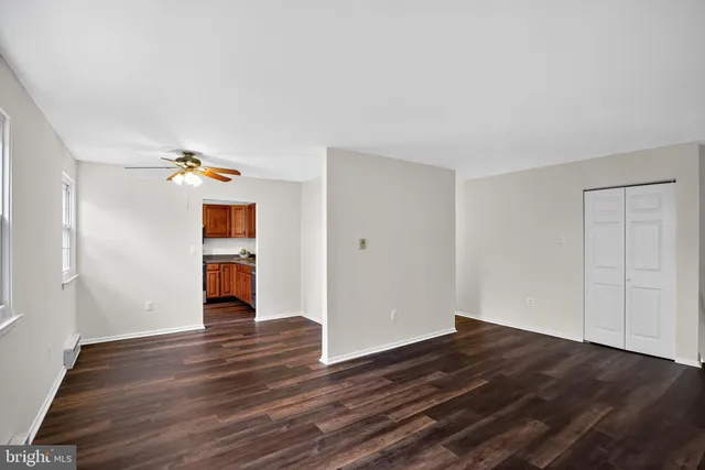 a view of empty room with wooden floor
