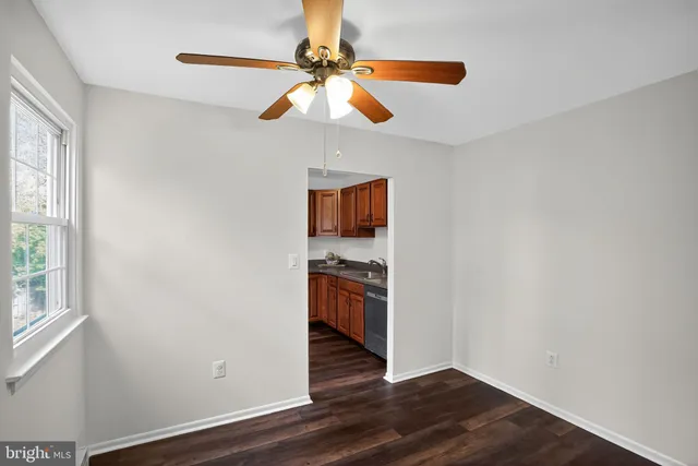 a view of a kitchen with wooden floor a sink and a window