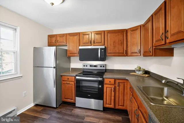 a kitchen with a refrigerator sink and stove