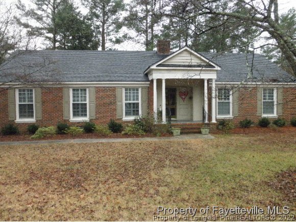 2723 Huntington Road Fayetteville, NC 28303 - Photo 1 of 25 a front view of a house with garden