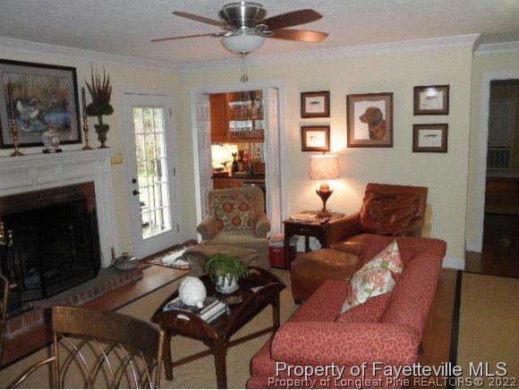 2723 Huntington Road Fayetteville, NC 28303 - Photo 11 of 25 a living room with furniture and a fireplace