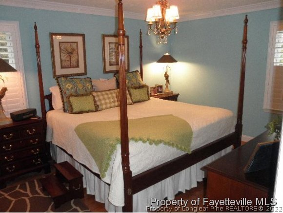 2723 Huntington Road Fayetteville, NC 28303 - Photo 12 of 25 a bedroom with a bed window and lamp