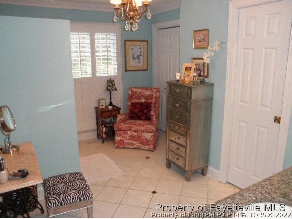 2723 Huntington Road Fayetteville, NC 28303 - Photo 13 of 25 a living room with furniture and a baby crib