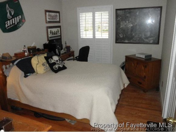 2723 Huntington Road Fayetteville, NC 28303 - Photo 16 of 25 a bedroom with a bed window and couch