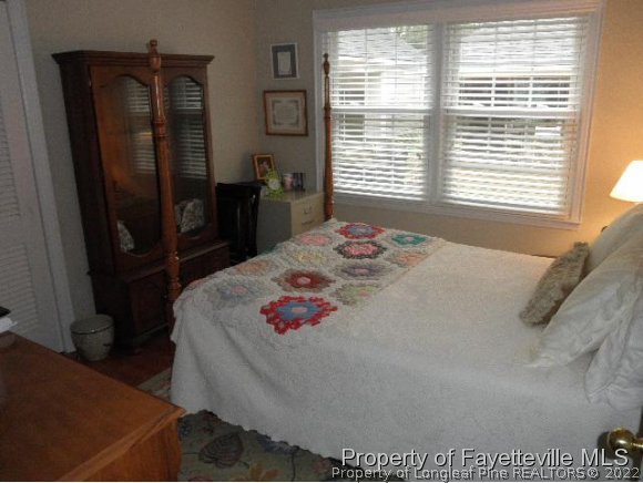 2723 Huntington Road Fayetteville, NC 28303 - Photo 17 of 25 a bedroom with a bed and a dresser next to a window