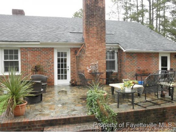 2723 Huntington Road Fayetteville, NC 28303 - Photo 18 of 25 front view of a house with potted plants