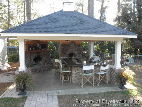 2723 Huntington Road Fayetteville, NC 28303 - Photo 20 of 25 a view of a patio with table and chairs under an umbrella