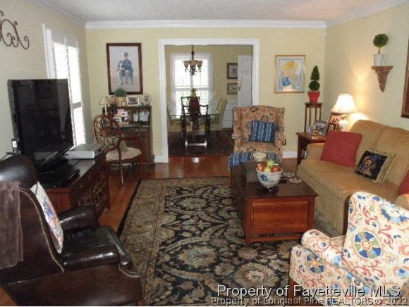 2723 Huntington Road Fayetteville, NC 28303 - Photo 4 of 25 a living room with furniture and a flat screen tv