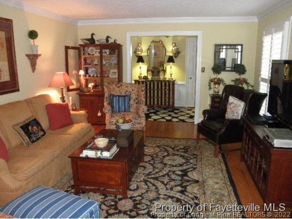 2723 Huntington Road Fayetteville, NC 28303 - Photo 5 of 25 a living room with furniture rug and wooden floor