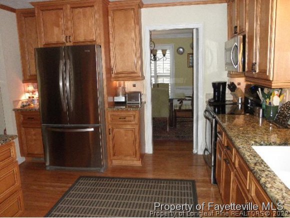 2723 Huntington Road Fayetteville, NC 28303 - Photo 8 of 25 a kitchen with stainless steel appliances granite countertop a refrigerator and a sink