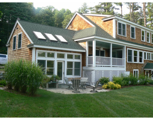 a front view of a house with a yard and porch
