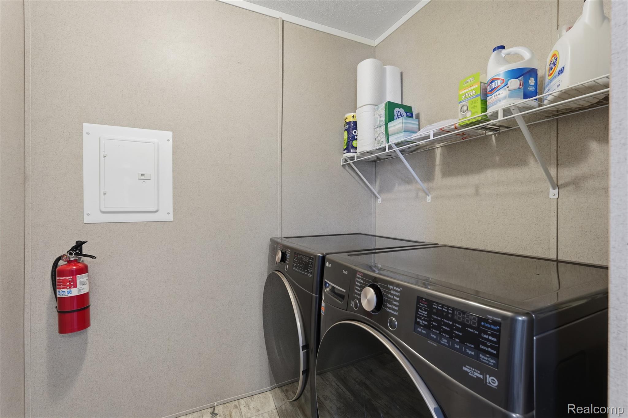 92 Normandy Drive Howell, MI 48843 - Photo 10 of 24 Dedicated utility area featuring panel-style walls, wire shelving, and wood-finish flooring