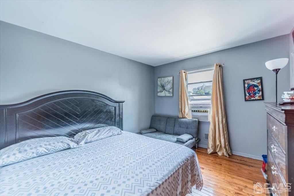 454 Mitchell Place Perth Amboy, NJ 08861 - Photo 14 of 36 a bedroom with a bed and a window