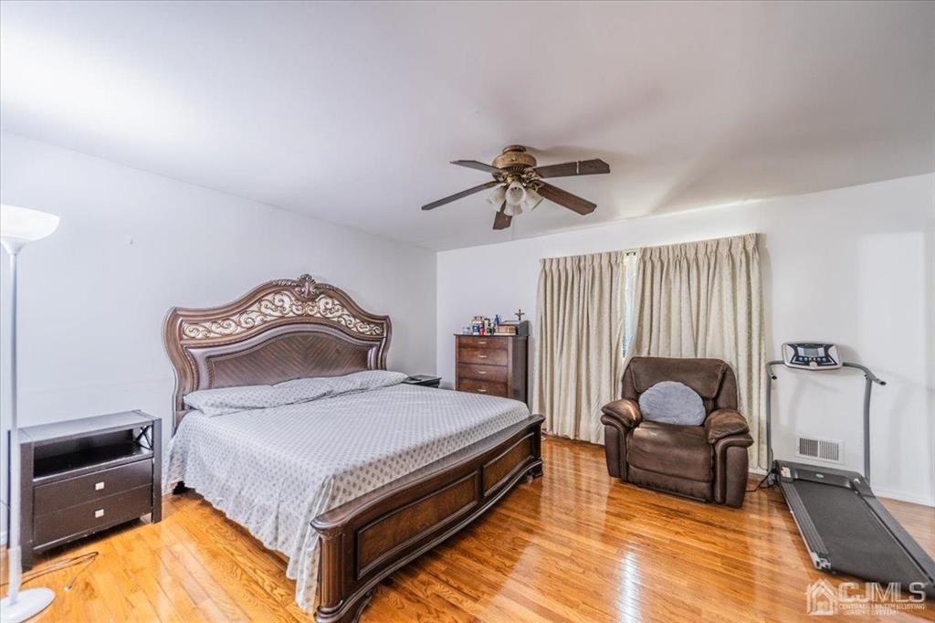 454 Mitchell Place Perth Amboy, NJ 08861 - Photo 16 of 36 a bedroom with a bed and window