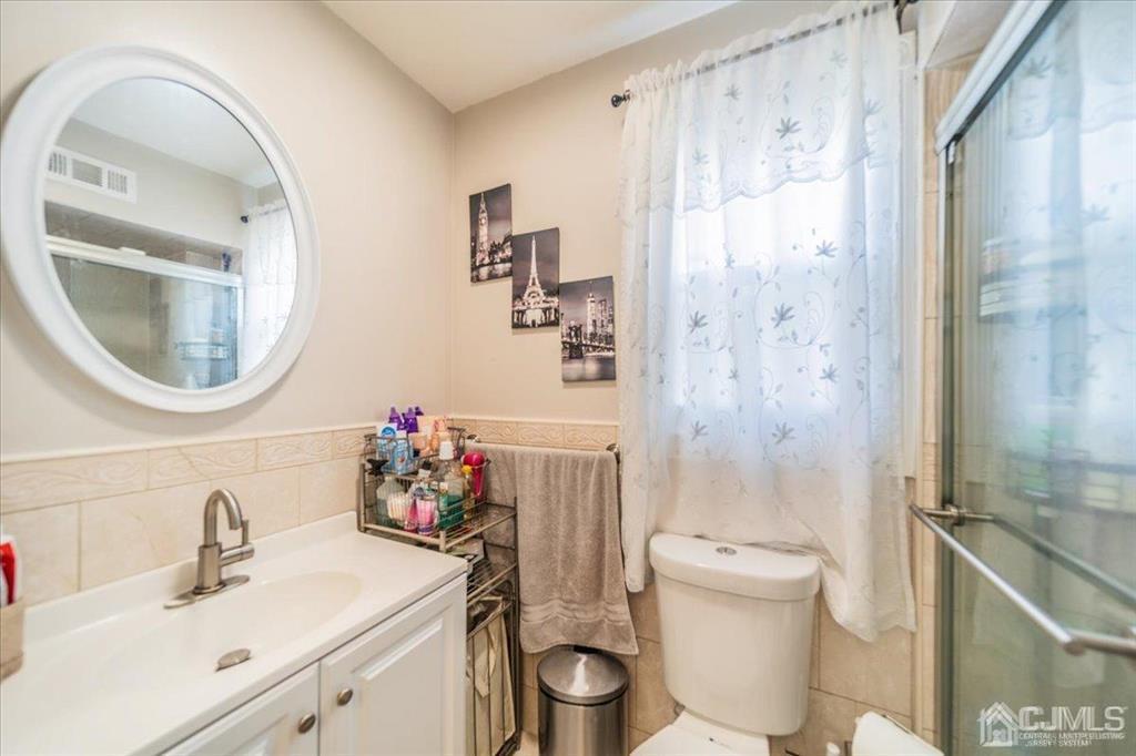 454 Mitchell Place Perth Amboy, NJ 08861 - Photo 24 of 36 a bathroom with a sink toilet and shower