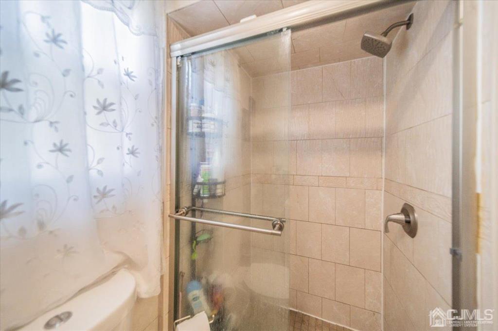 454 Mitchell Place Perth Amboy, NJ 08861 - Photo 25 of 36 a bathroom with a bathtub and a shower