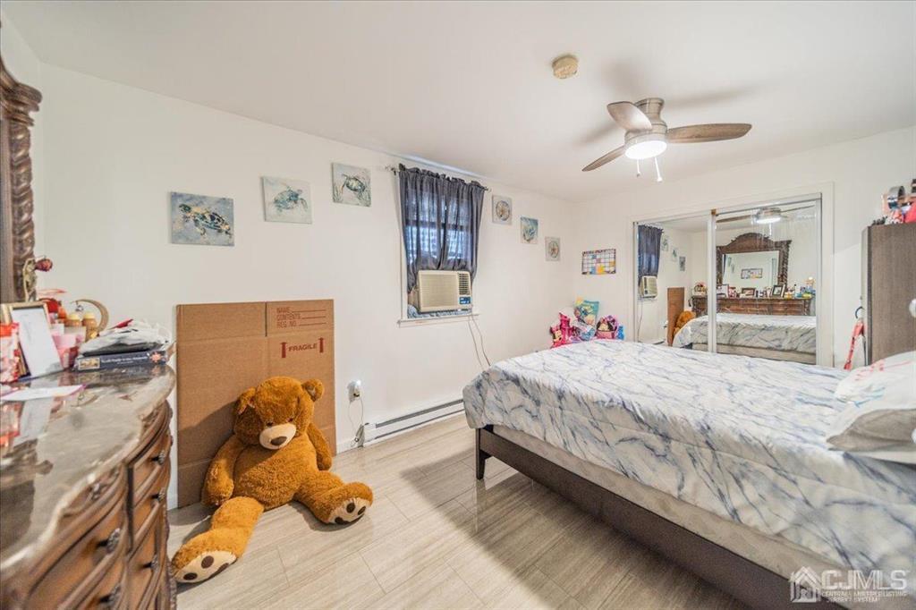 454 Mitchell Place Perth Amboy, NJ 08861 - Photo 27 of 36 a bed room with a bed and a dresser