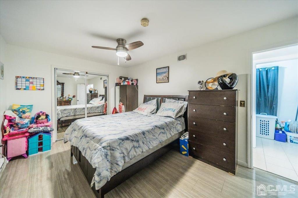 454 Mitchell Place Perth Amboy, NJ 08861 - Photo 28 of 36 a bedroom with a bed and a dresser