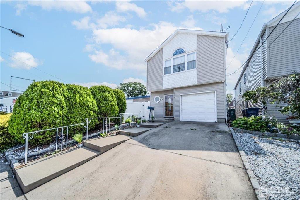 454 Mitchell Place Perth Amboy, NJ 08861 - Photo 3 of 36 a front view of a house with garden