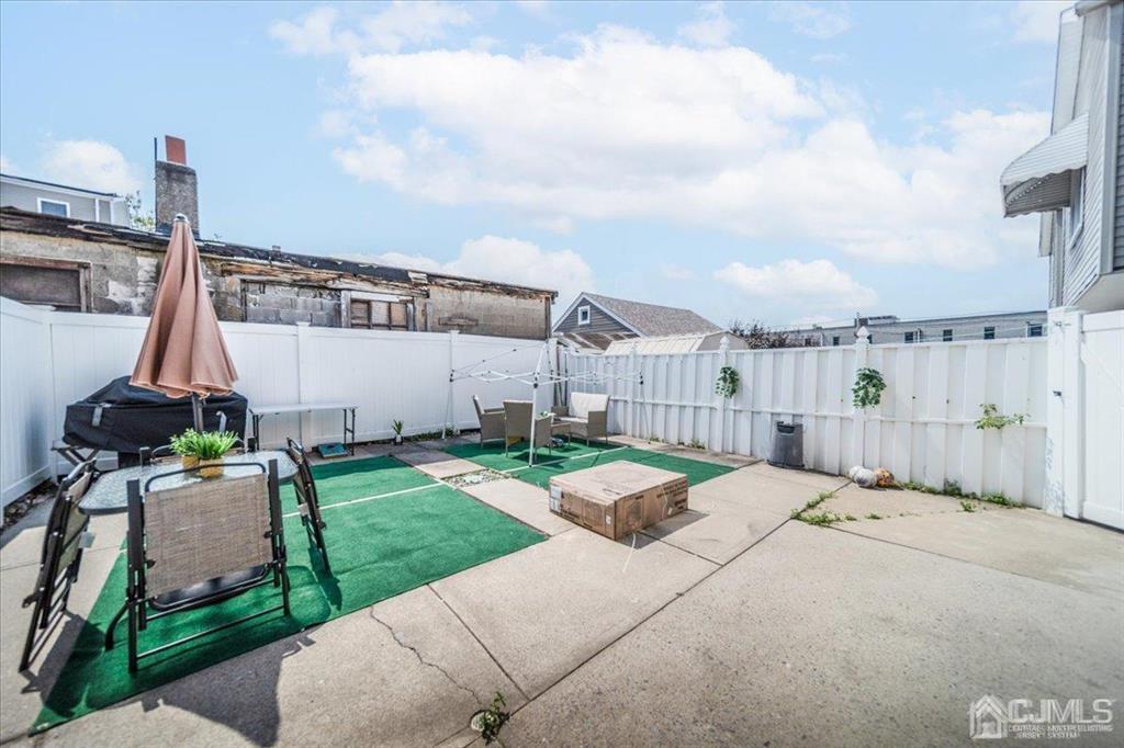 454 Mitchell Place Perth Amboy, NJ 08861 - Photo 33 of 36 a view of a patio with a table and chairs