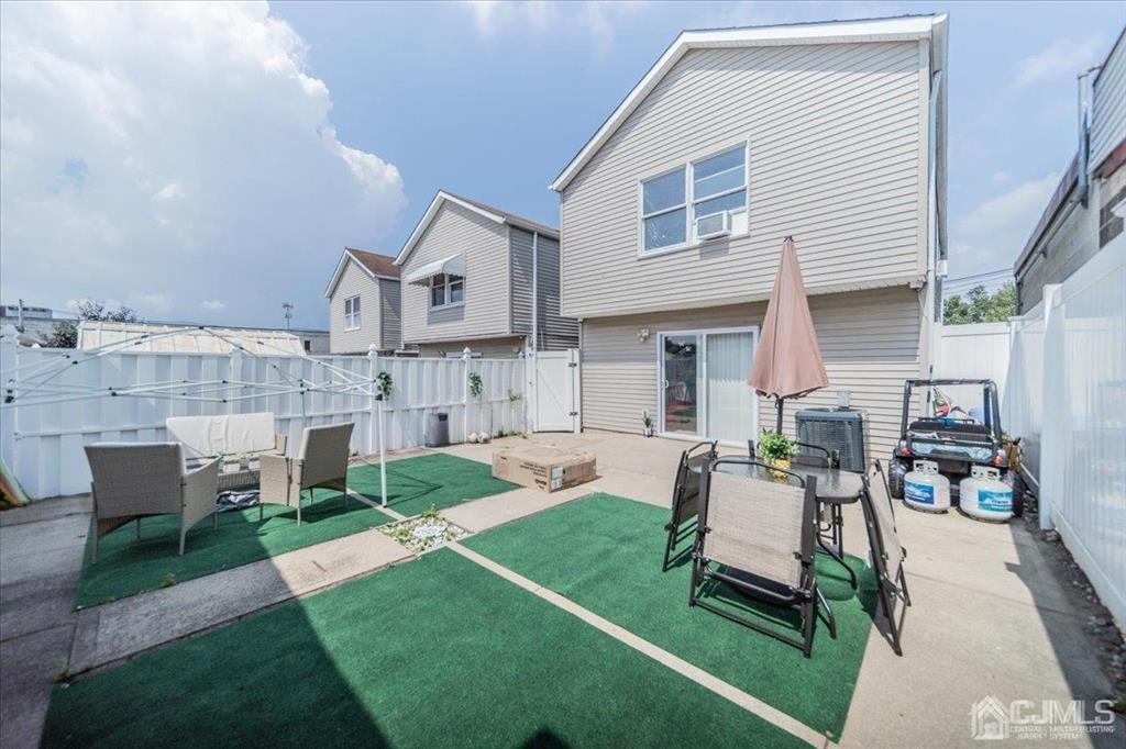 454 Mitchell Place Perth Amboy, NJ 08861 - Photo 34 of 36 a view of a house with a yard and sitting area