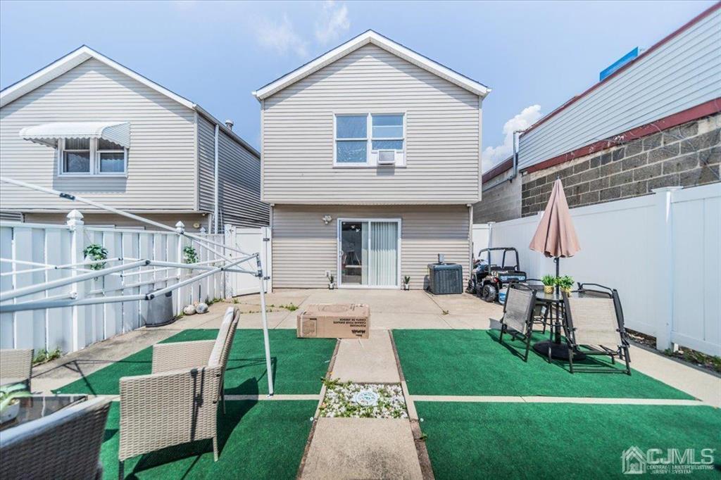 454 Mitchell Place Perth Amboy, NJ 08861 - Photo 35 of 36 a view of a house with a yard and sitting area