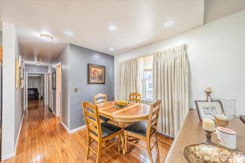 454 Mitchell Place Perth Amboy, NJ 08861 - Photo 6 of 36 a dining room with furniture and wooden floor