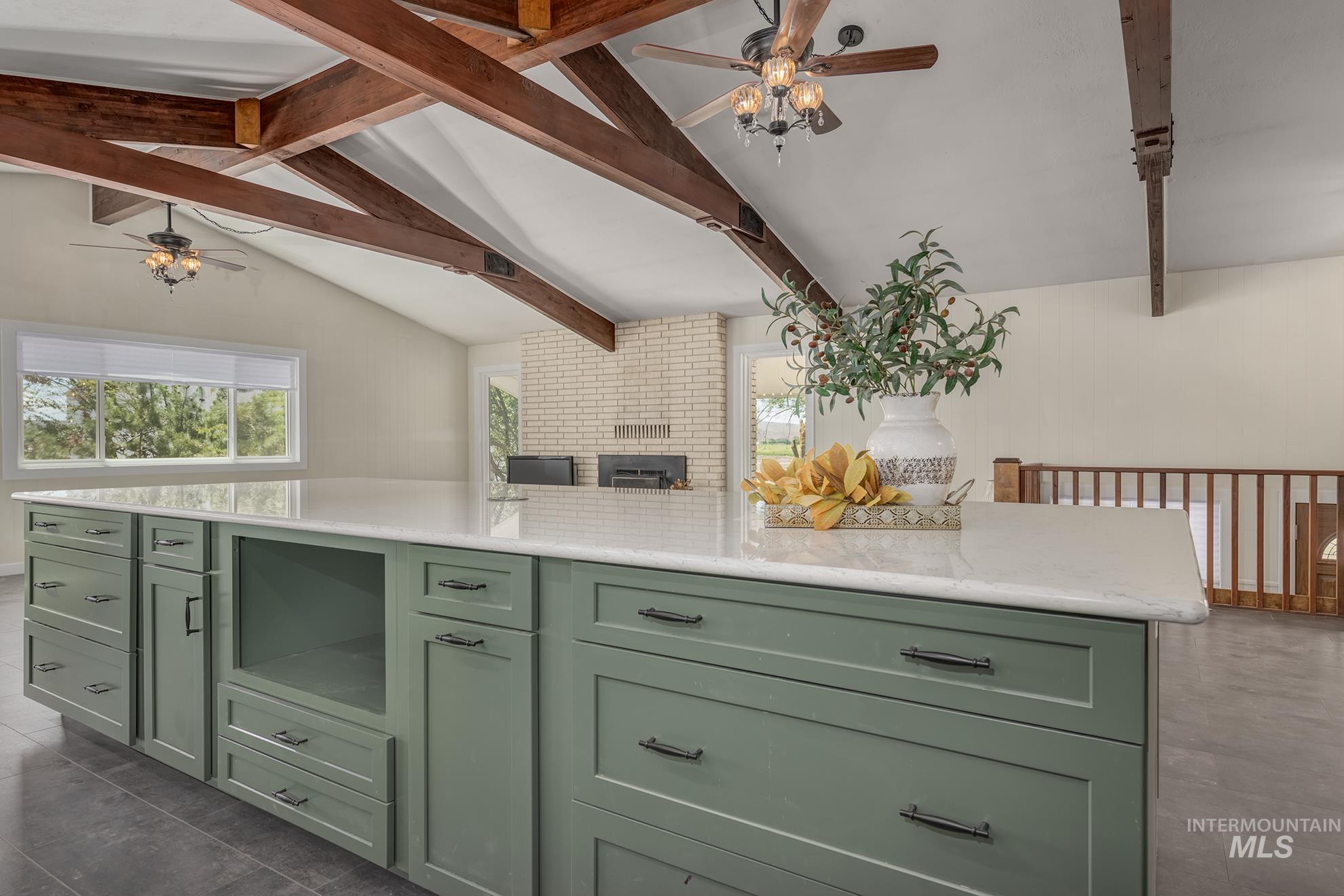 748 Pringle Road Weiser, ID 83672 - Photo 11 of 47 Kitchen island featuring a light-toned countertop and green cabinetry