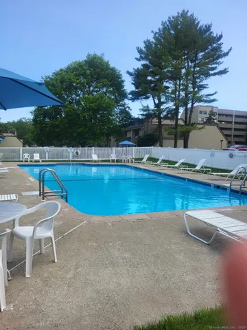 a view of a swimming pool with outdoor seating and plants