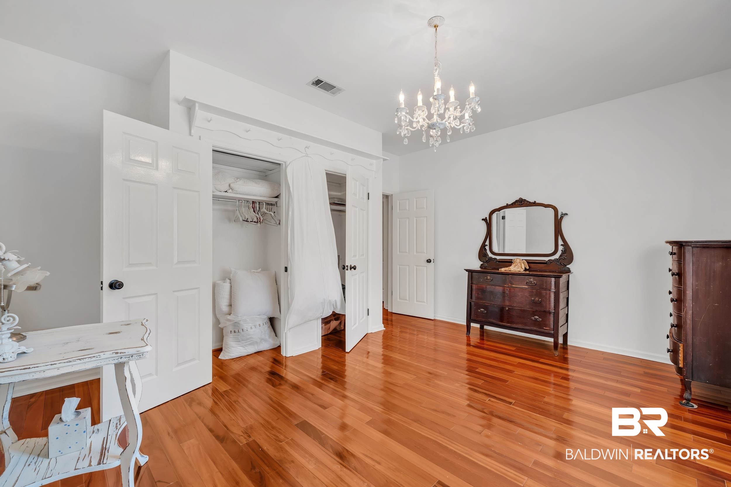 2 Navy Lane Daphne, AL 36527 - Photo 23 of 28 Bedroom featuring light wood finished floors, a chandelier, and a closet