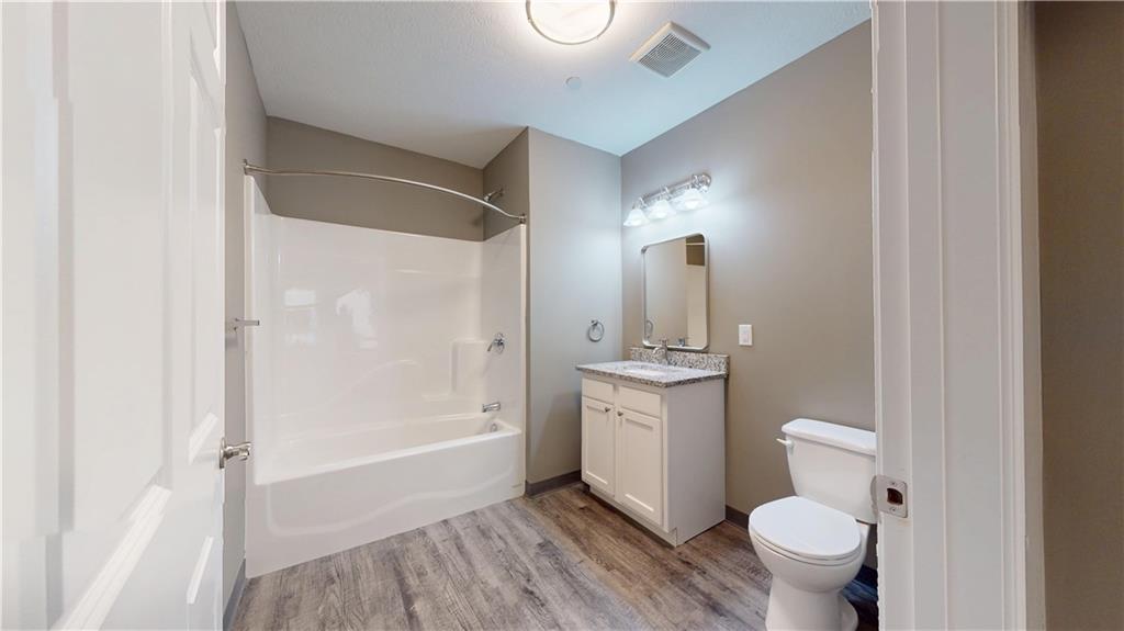 1450 Fifth Avenue, Unit 305 Pittsburgh, PA 15219 - Photo 11 of 22 a bathroom with a granite countertop sink a toilet and shower