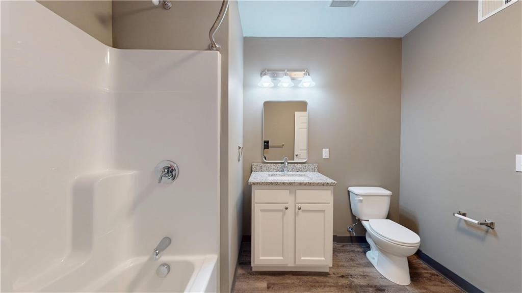 1450 Fifth Avenue, Unit 305 Pittsburgh, PA 15219 - Photo 12 of 22 a bathroom with a granite countertop toilet a sink and mirror