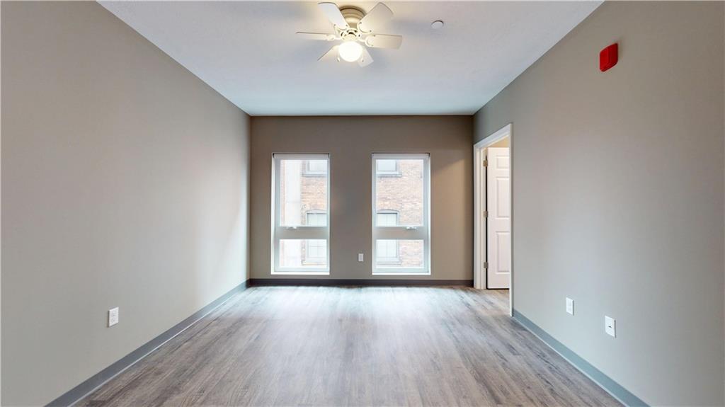 1450 Fifth Avenue, Unit 305 Pittsburgh, PA 15219 - Photo 14 of 22 wooden floor in an empty room with a window