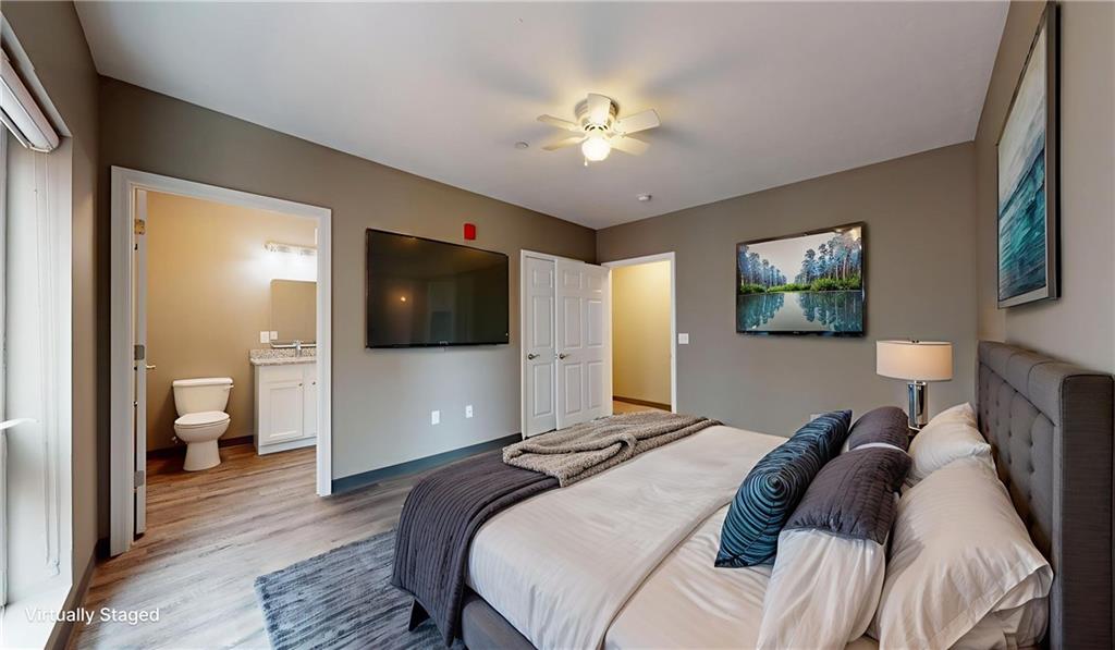 1450 Fifth Avenue, Unit 305 Pittsburgh, PA 15219 - Photo 16 of 22 a bedroom with a bed and a chandelier