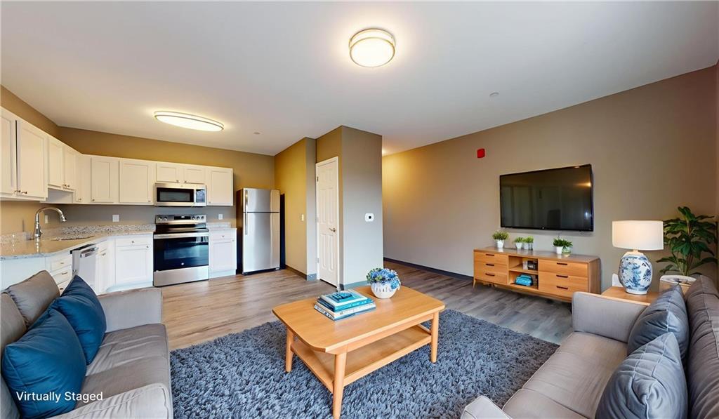 1450 Fifth Avenue, Unit 305 Pittsburgh, PA 15219 - Photo 21 of 22 a living room with furniture and a flat screen tv