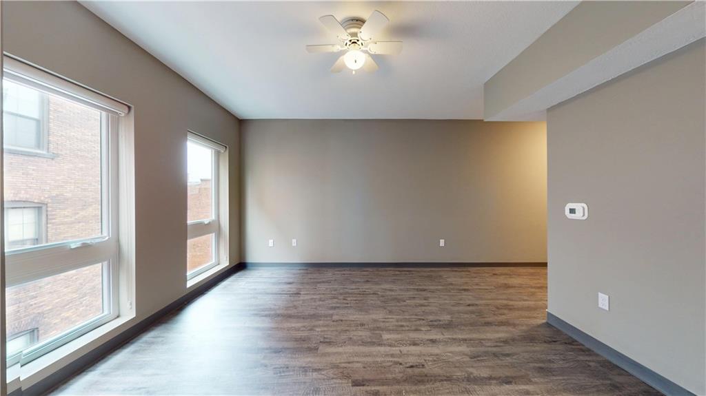 1450 Fifth Avenue, Unit 305 Pittsburgh, PA 15219 - Photo 7 of 22 a view of an empty room and window and chandelier fan