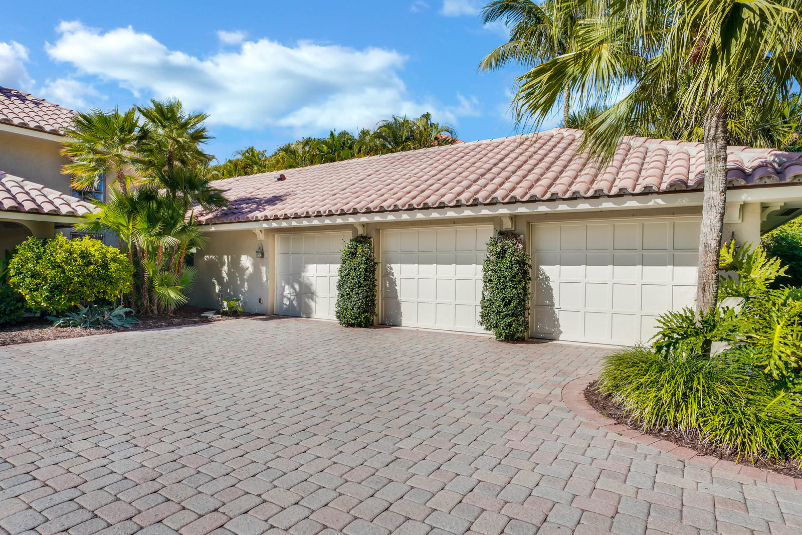 143 Point Circle Tequesta, FL 33469 - Photo 15 of 41 a front view of a house with a garden